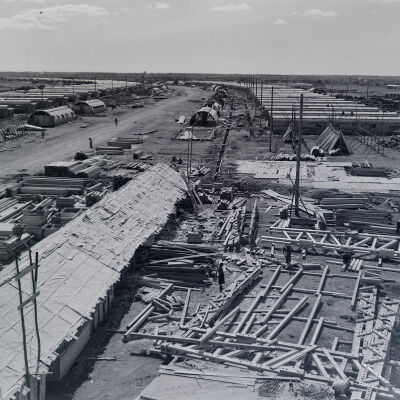 Aerial view of a Quonset hut camp area under construction