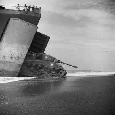 Tank exiting a landing craft onto beach