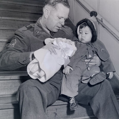 Soldier giving toys to a Japanese toddler