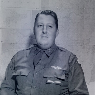Portrait of Captain Frye in front of wall map