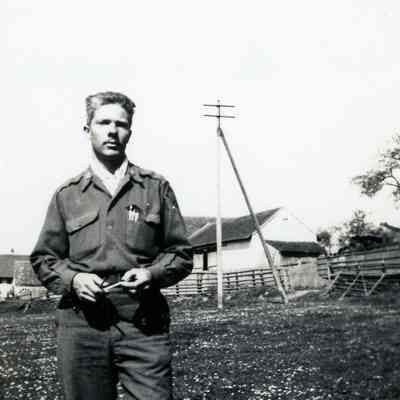 Officer standing in a farm field