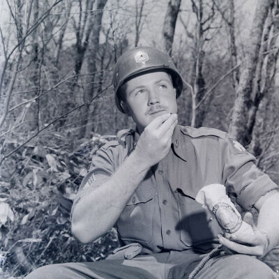 Soldier placing chewing tobacco in his mouth