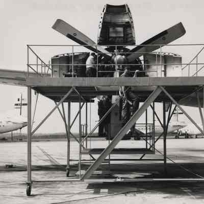 Maintenace crew works on airplane engine