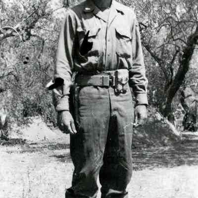 Officer in front of trees