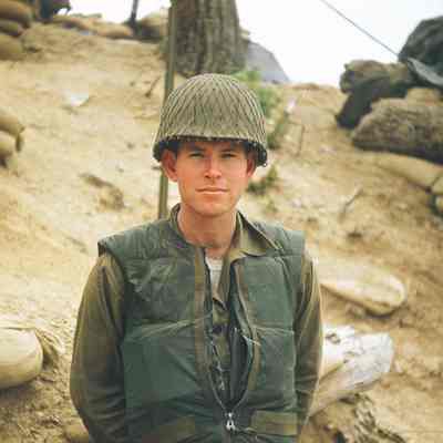 Portrait of soldier standing in front of sandbags