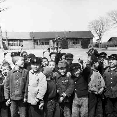 Japanese children standing in front of school