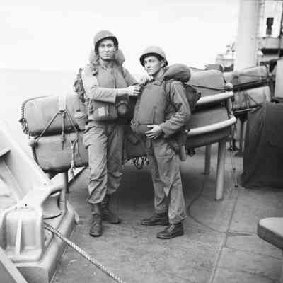 Soldiers checking each other's life vests