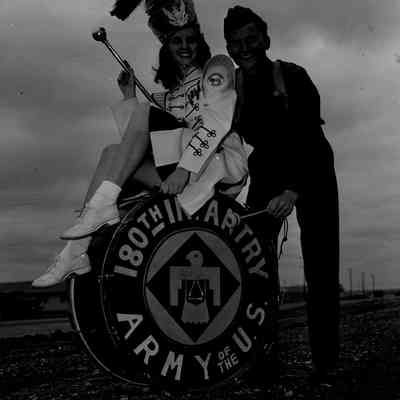 Drum majorette sitting on bass drum