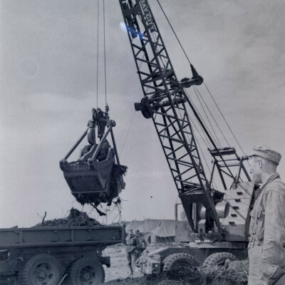 Soldiers operating clamshell shovel