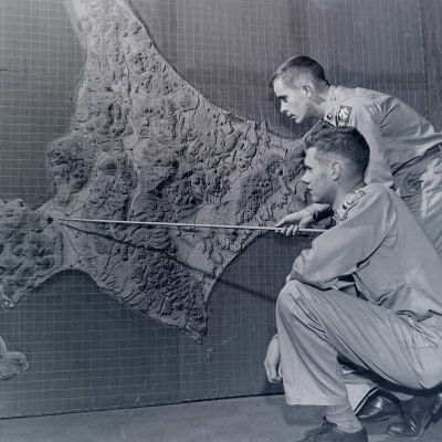 Two soldiers looking at relief map of Hokkaido