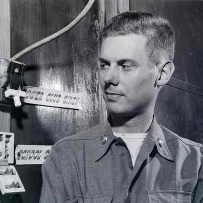 Soldier eyeing electrical switch for a siren