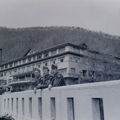 Soldiers on bridge with hotel in background