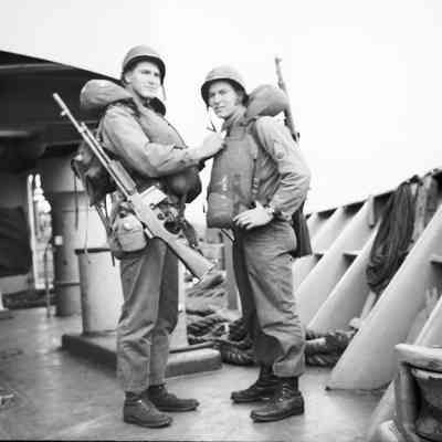 Soldiers checking each other's life vests
