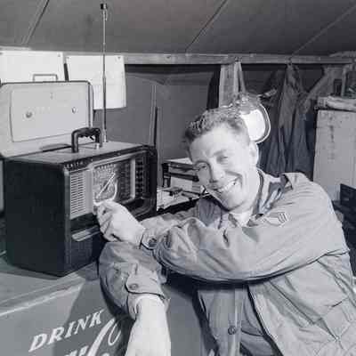 Soldier posing next to radio
