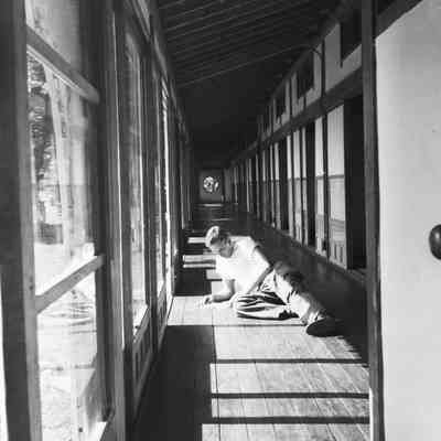 Soldier relaxing in a sunny hallway in the Noboribetsu Hotel