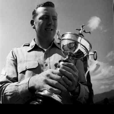 Soldier holding a baseball trophy