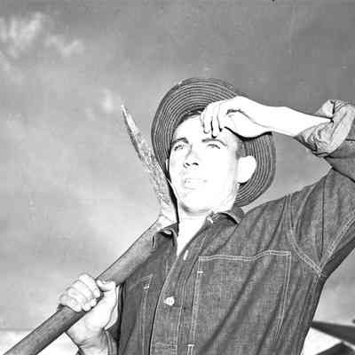 Soldier in dungarees posed with a pick