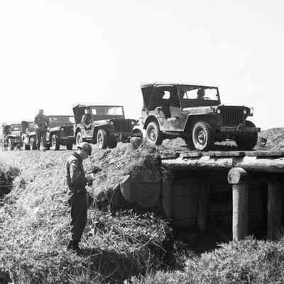 Soldier checking bridge structure before jeep crossing
