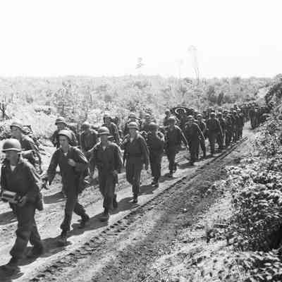 Soldiers on a road march in a rural area