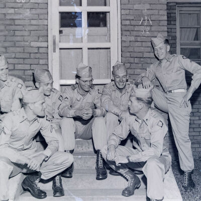 Soldiers sitting on front steps