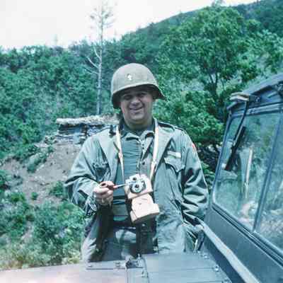 Chaplain posing with a pipe and camera