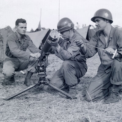 Machine gun crew cleaning their weapon in camp