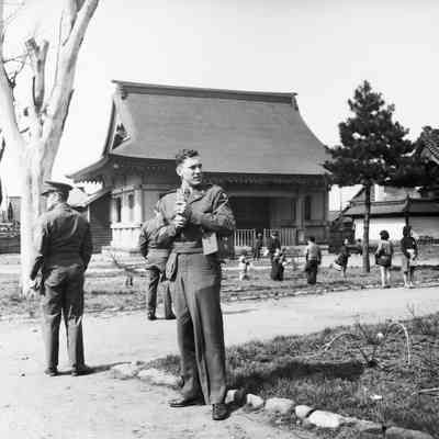 Soldiers in a Japanese village with cameras