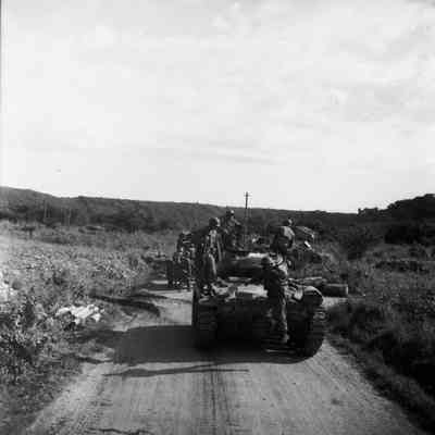 Tank convoy traveling down dirt road
