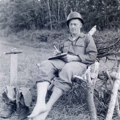 Soldier relaxing outside in homemade chair