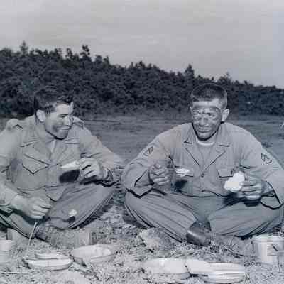 Soldiers eating out of their mess kits
