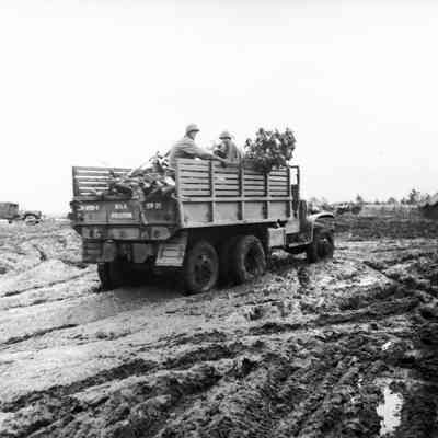 Truck carrying soldiers through deep mud