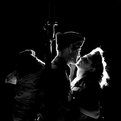 Soldier and woman about to kiss