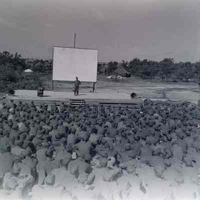 Soldiers watching person on stage
