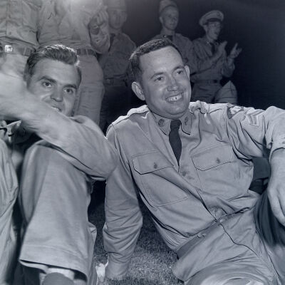Two soldiers applauding during a show
