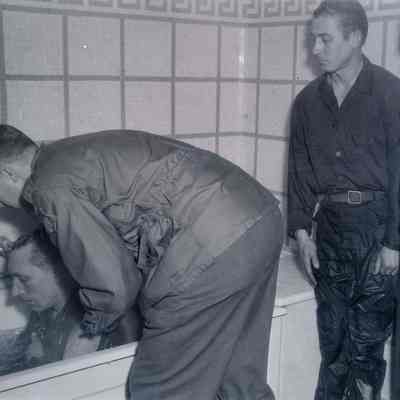 Soldier being baptized in bathtub