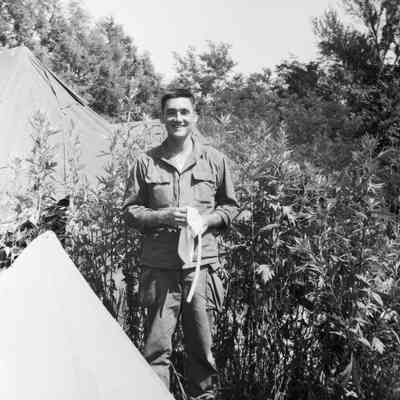 Soldier standing in front of tents