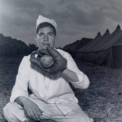 Cook posing with baseball glove and baseball