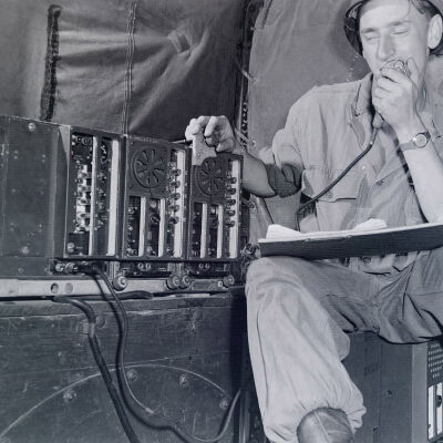 Soldier operating truck-mounted radio gear