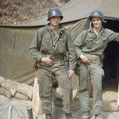 Soldiers posing in front of tent
