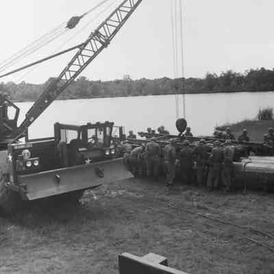 Soldiers training to construct a pontoon bridge