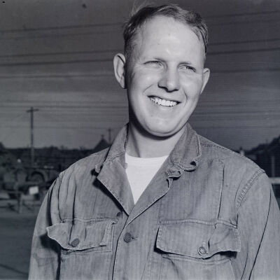 Portrait of unknown soldier with camp area in the background