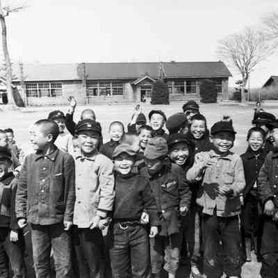 Japanese children standing in front of school