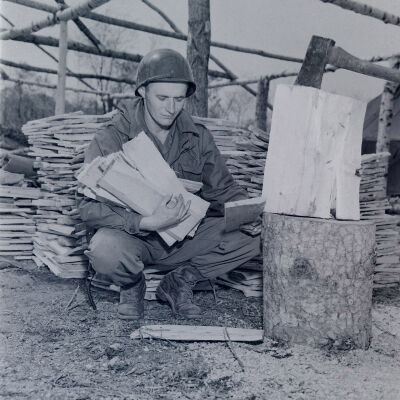 Soldier collecting split wood