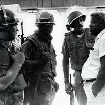 Soldiers talking with a man