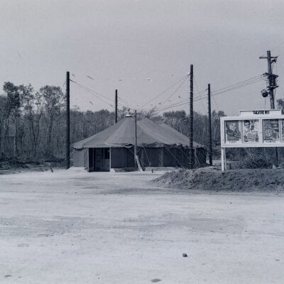 Theater marquee in front of large tent