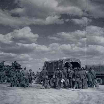 Soldiers boarding transport trucks