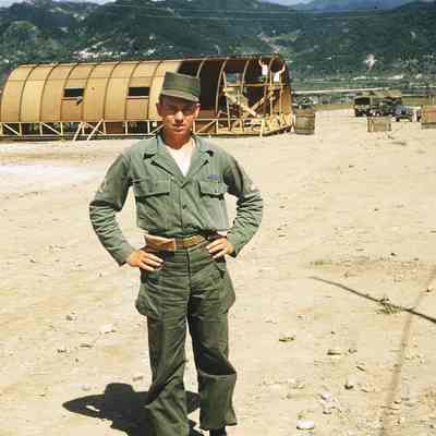 Norbert Haverkamp in front of a Quonset hut under construction