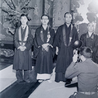 Group of Japanese men in ceremonial dress being photographed by Army photographer