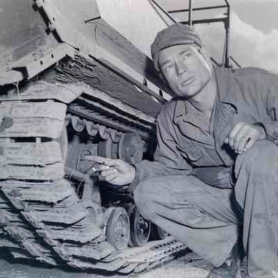 Soldier pointing to the tracks on an amphibious tracked vehicle