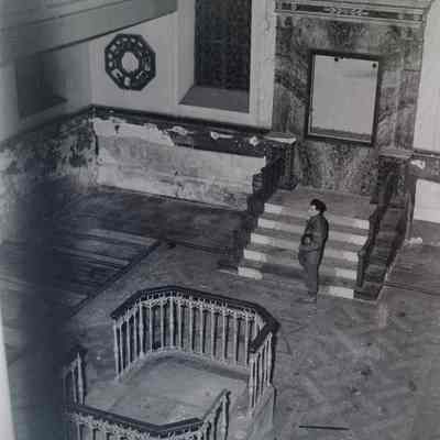 Soldier stands inside a destroyed synagogue